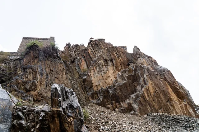 Ancient Stone Fortress on Steep Mountain Cliff