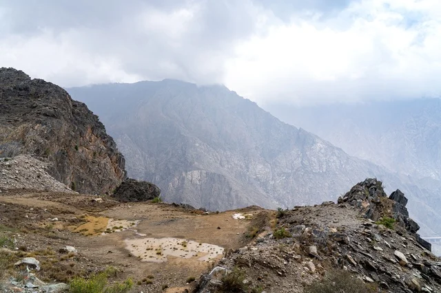 Rocky Mountain Landscape Under Foggy Cloudy Sky