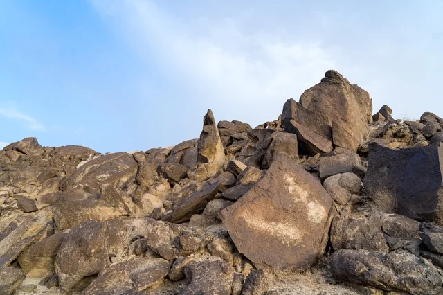 Brown Volcanic Rock Formations Under Blue Sky