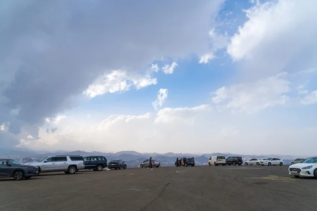 Parked Cars at Mountain Viewpoint Under Cloudy Sky Parked Cars at Mountain Viewpoint Under Cloudy Sky