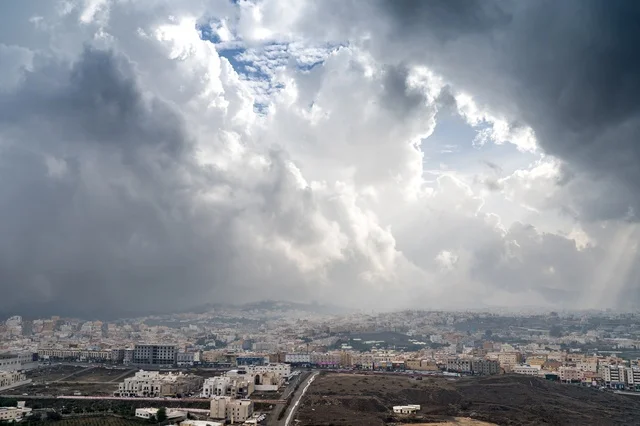 Heavy Storm Clouds Over Urban Middle Eastern Cityscape