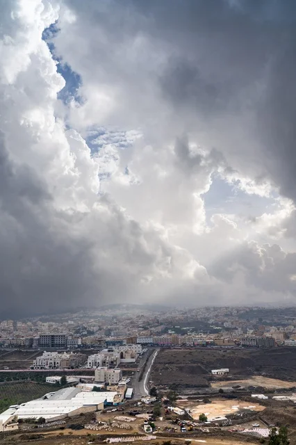 Dramatic Storm Clouds Over Coastal City Landscape