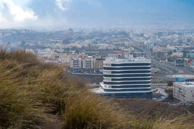 Modern Office Building in Hazy Urban City Valley