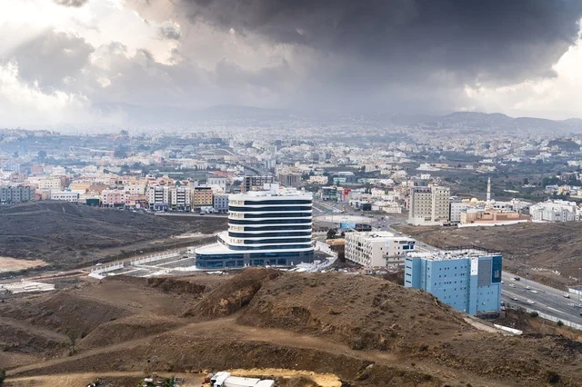 Modern Building and Urban Cityscape Under Stormy Clouds