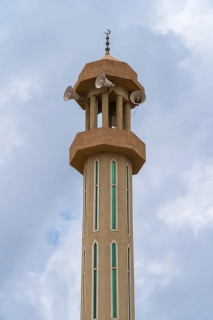 Mosque Minaret with Loudspeakers under Cloudy Sky