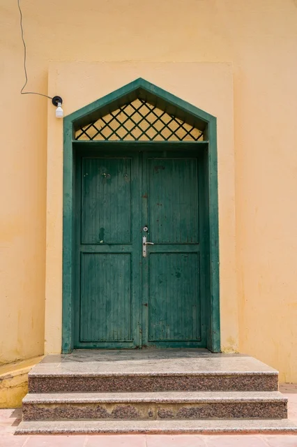 Traditional Green Wooden Door with Stone Steps