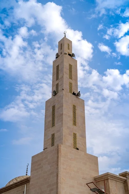 Traditional Stone Mosque Minaret Under Blue Sky