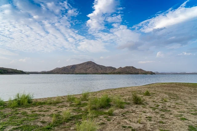 Lake and Rocky Mountains Landscape Under Blue Sky