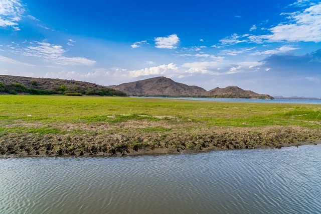 Green Valley and Lake with Mountain Background Landscape