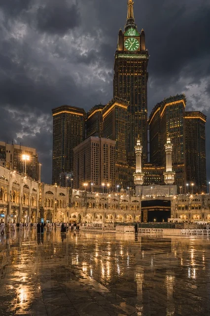 Kaaba and Makkah Clock Tower at Night with Reflections
