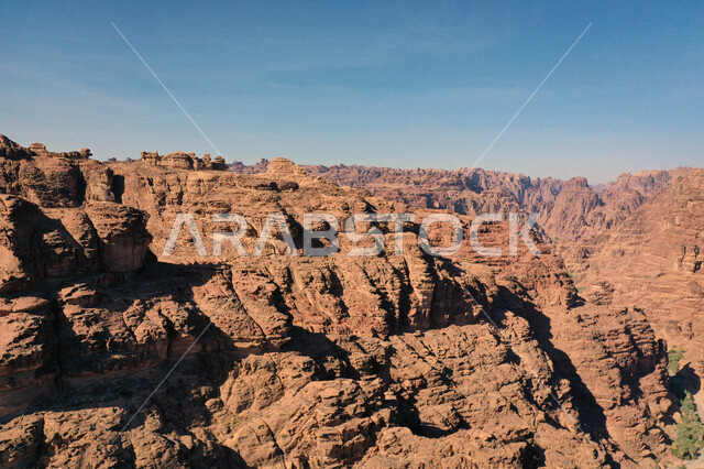 An aesthetic picture of the charming mountain canyons, rock formations and oases in Wadi Al-Disah in the Tabuk region, Wadi Al-Disah (the valley filled with palms) the charming nature and its scenic beauty in the Kingdom of Saudi Arabia