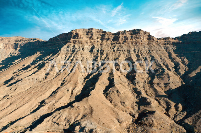 An aesthetic picture of the charming mountain canyons, rock formations and oases in Wadi Al-Disah in the Tabuk region, the charming nature and its scenic beauty in the Kingdom of Saudi Arabia