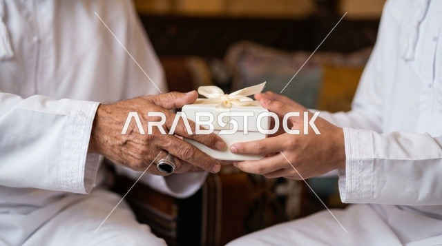 Elderly Saudi Man Handing Gift Box Close Up
