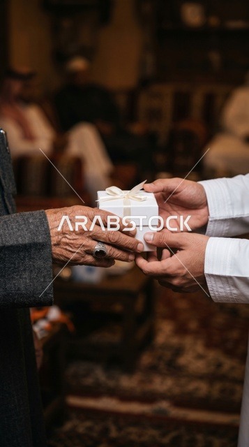 Giving Gift Box to Elderly Man During Charity Distribution