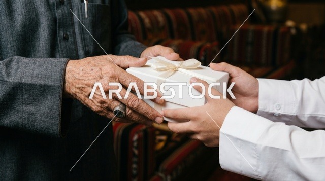 Elderly Hands Receiving White Gift Box Close Up Detail