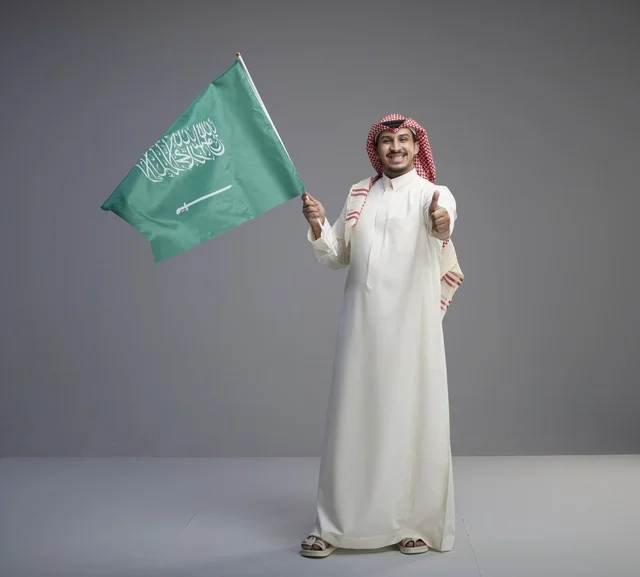Saudi Man Waving National Flag with Thumbs Up