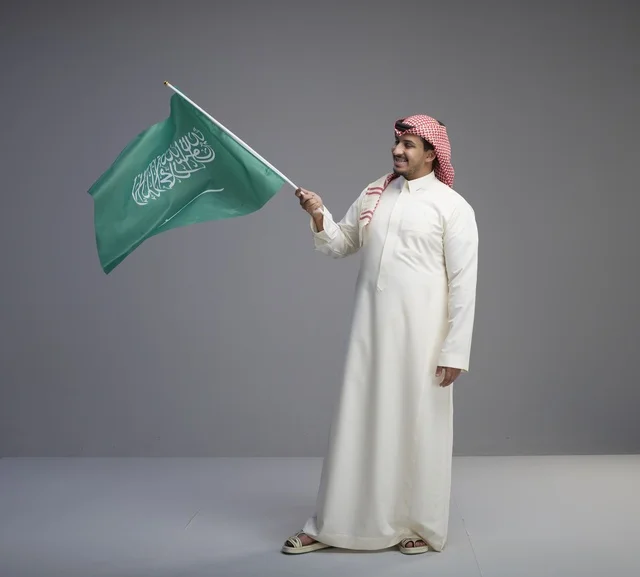Saudi Man Waving Saudi Arabia National Flag in Studio