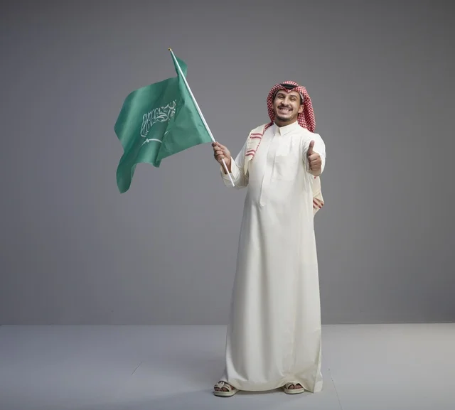 Saudi Man Holding National Flag with Thumbs Up