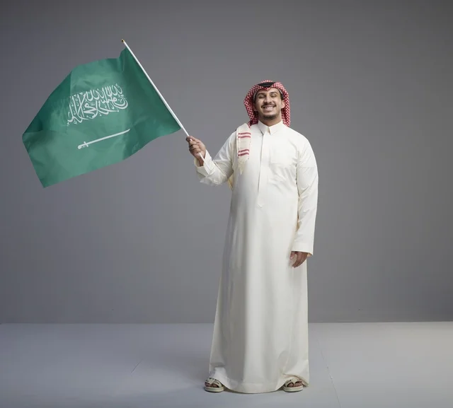 Saudi Man Waving Saudi Arabia Flag in Studio