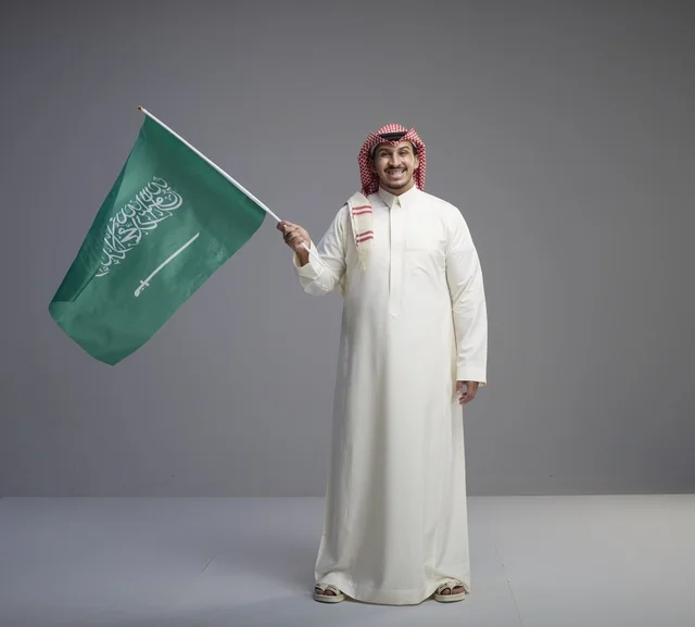 Saudi Man Holding National Flag in Studio