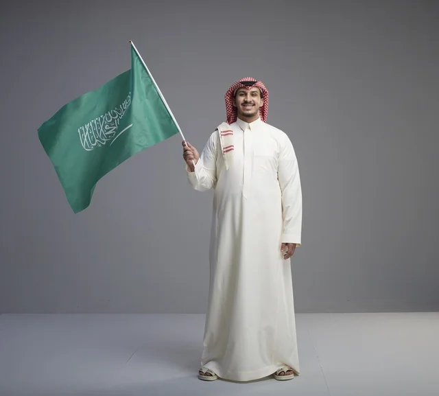 Saudi Man Holding Saudi Arabian National Flag