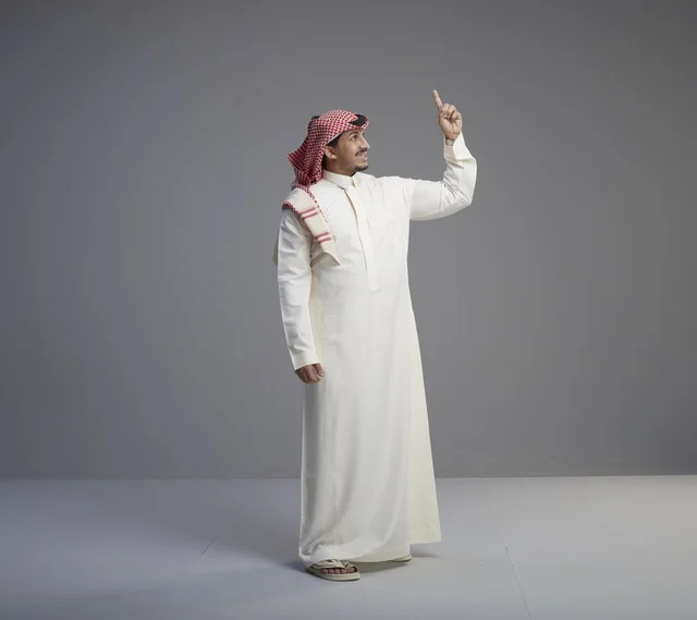 Saudi Man in Traditional Thobe Pointing Upward