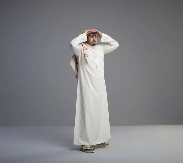 رجل سعودي بالزي التقليدي بتعبير وجه مندهش