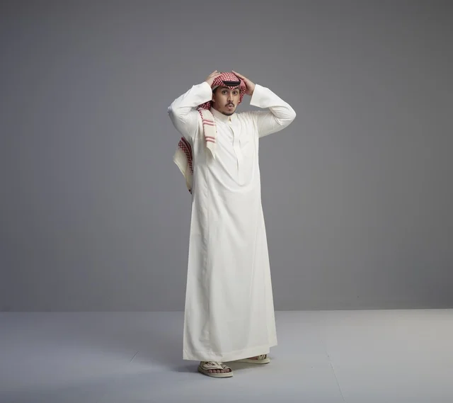Saudi Man in Traditional White Thobe Standing in Studio