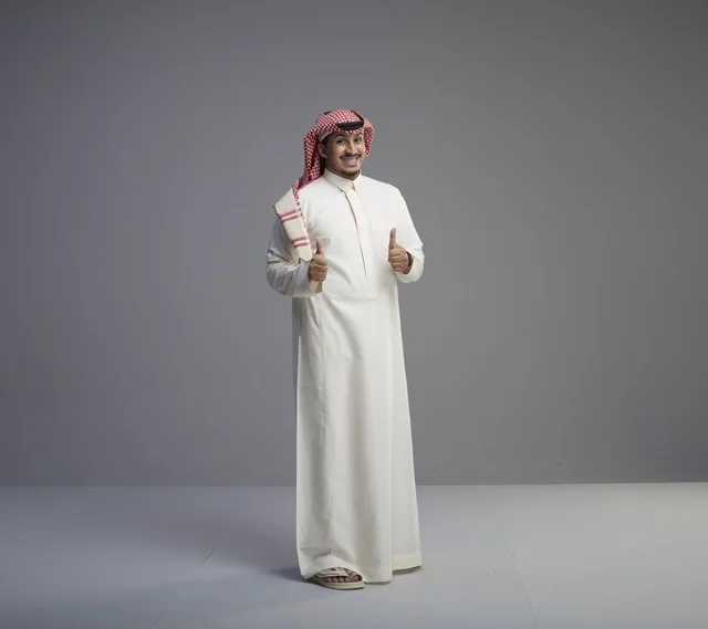 Saudi Man in Traditional Thobe Giving Thumbs Up