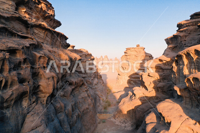 A picture of the rock formations in the Bajdah Neom region, northwest of the Kingdom of Saudi Arabia, beautiful landscapes of golden sand, mountains with attractive rock formations in Tabuk, cultural and tourist attractions in the Kingdom of Saudi Arabia.