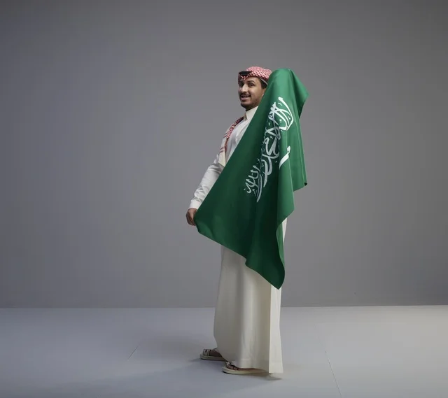 Saudi Man Holding National Flag in Studio