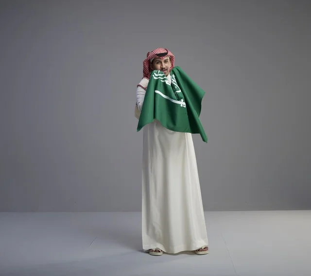 Saudi Man Holding National Saudi Flag in Studio