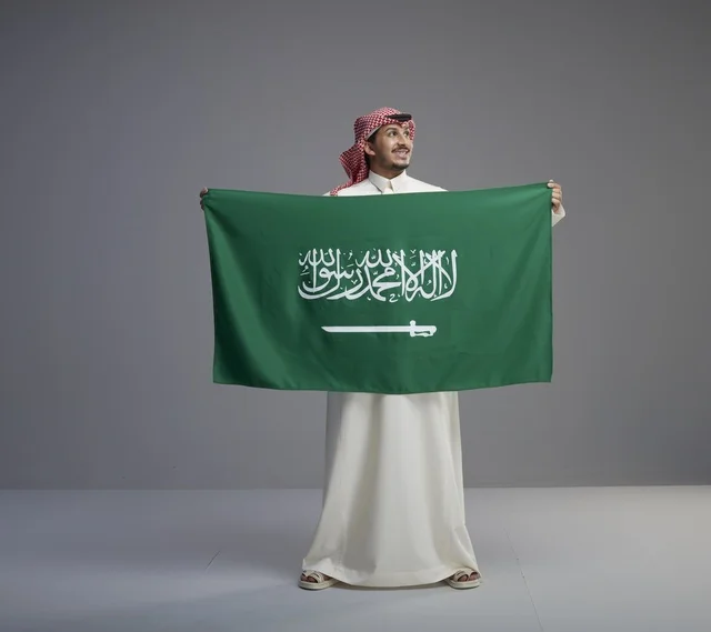 Saudi Man Holding National Flag in Studio