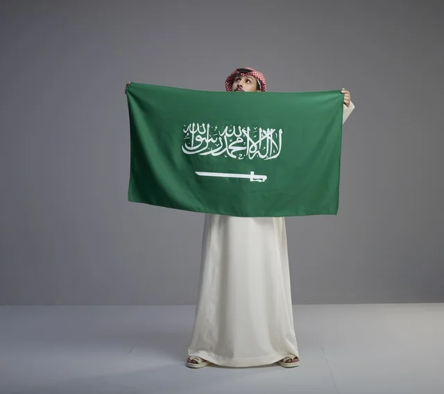 Saudi Man Holding National Flag in Studio