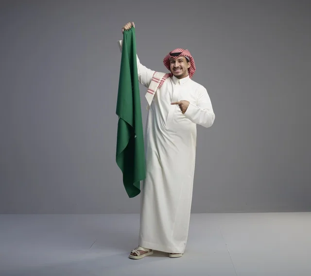 Saudi Man Holding Saudi Arabia National Flag in Studio