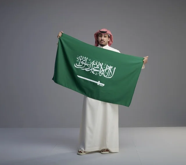 Saudi Man Holding the Saudi National Flag