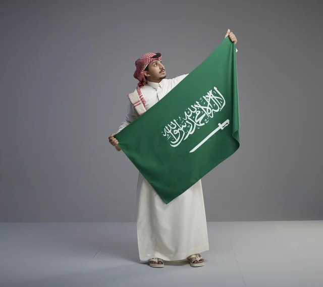 Saudi Man Holding National Saudi Arabia Flag in Studio