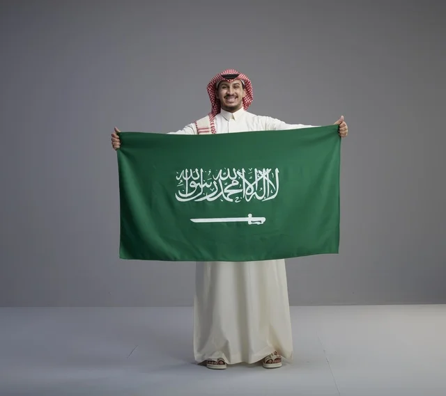 Saudi Man Holding National Flag in Studio Portrait