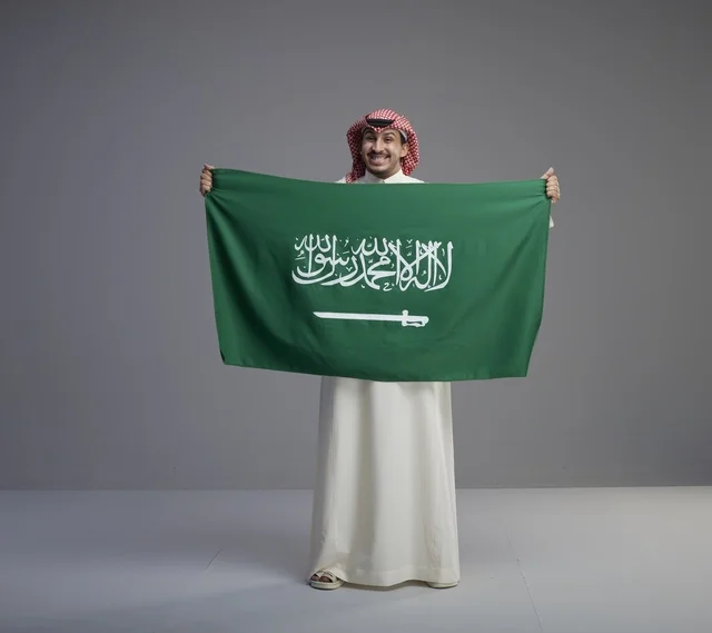 Saudi Man Holding National Saudi Flag in Studio