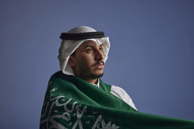 Saudi Man Wrapped in National Flag Studio Portrait