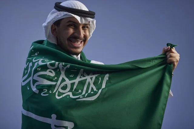 Saudi Man Wrapped in Saudi Arabia Flag Portrait