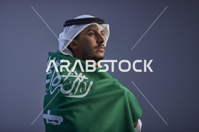 Saudi Man Wrapped in Saudi Flag Studio Portrait