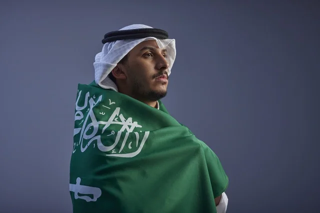 Saudi Man Wrapped in Saudi Flag Studio Portrait