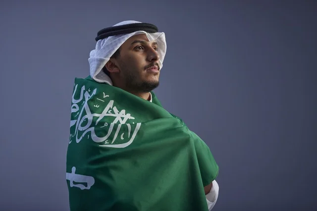 Saudi Man Wrapped in National Flag Studio Portrait