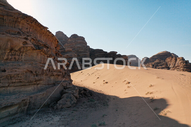 A picture of the rock formations in the Bajdah Neom region, northwest of the Kingdom of Saudi Arabia, beautiful landscapes of golden sand, mountains with attractive rock formations in Tabuk, cultural and tourist attractions in the Kingdom of Saudi Arabia.