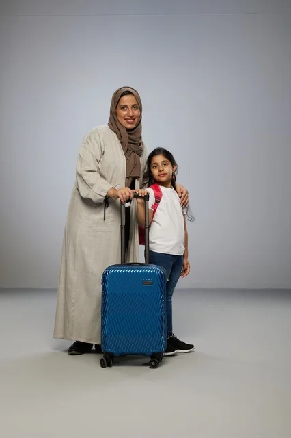Saudi Mother and Daughter with Suitcase in Studio