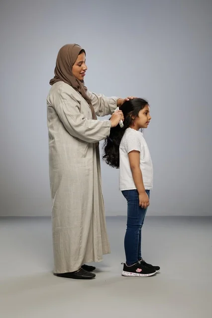 Saudi Mother Brushing Daughter Long Hair Profile View