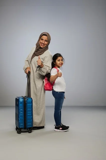 أم وابنتها سعوديات مع حقيبة سفر للسياحة