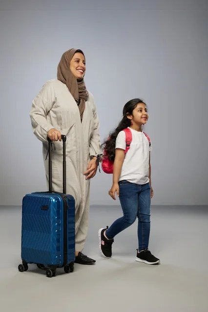أم وابنتها السعوديتان تسافران مع حقيبة سفر زرقاء