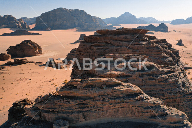 A picture of the rock formations in the Bajdah Neom region, northwest of the Kingdom of Saudi Arabia, beautiful landscapes of golden sand, mountains with attractive rock formations in Tabuk, cultural and tourist attractions in the Kingdom of Saudi Arabia.